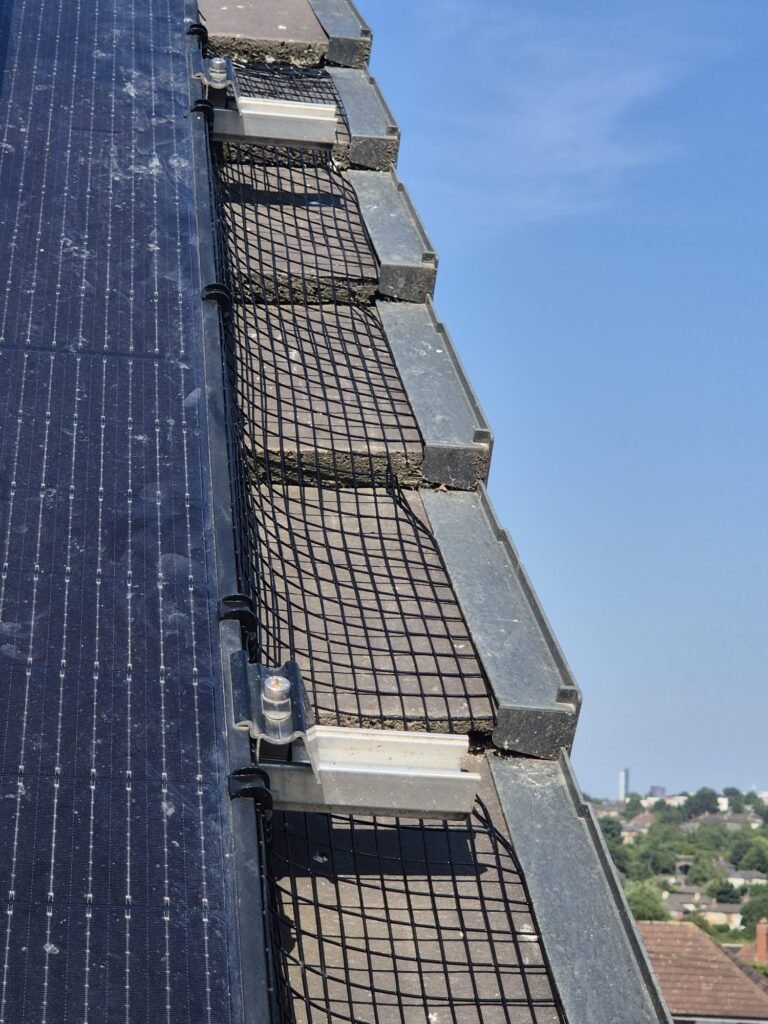 Side view of pigeon proofing mesh fitted beneath solar panels in Leeds LS15.