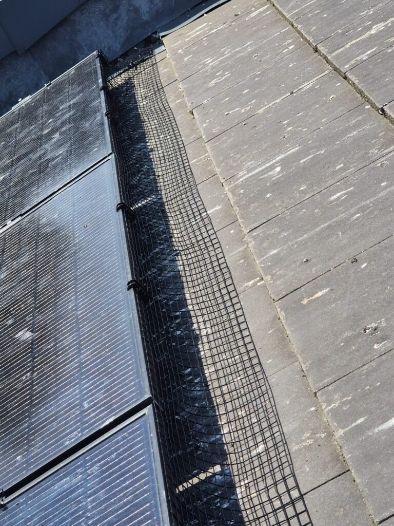 Top view of solar panel pigeon proofing mesh professionally installed on a home in Leeds LS15.