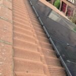Black PVC-coated galvanised mesh fitted along the edge of solar panels with UV-rated Solar Fast Fix clips.