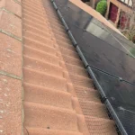 Black PVC-coated galvanised mesh fitted along the edge of solar panels with UV-rated Solar Fast Fix clips.