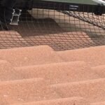 Black PVC-coated solar pigeon-proofing mesh secured around solar panels with UV-rated Solar Fast Fix clips.
